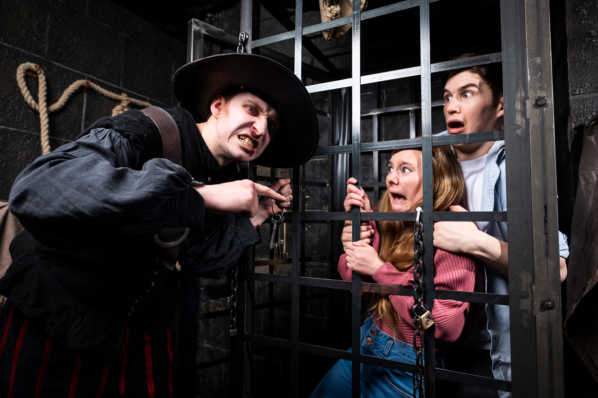 Group behind bars at the Escape Room London Dungeon